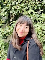 Beverly Conrique, Ph.D. in front of greenery